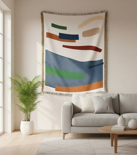 Abstract tapestry hanging above a sofa in a living room
