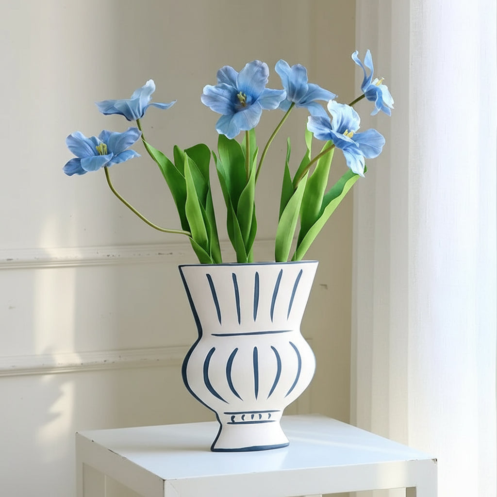 Nordic hand-painted flower vase with blue tulips on a white surface