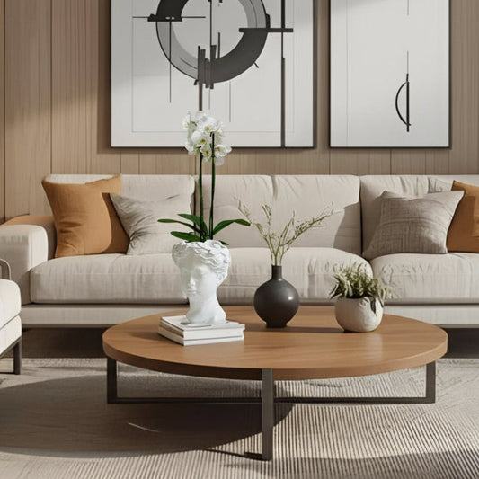 Modern living room with a beige sofa, wooden coffee table, and a resin bust vase with an orchid