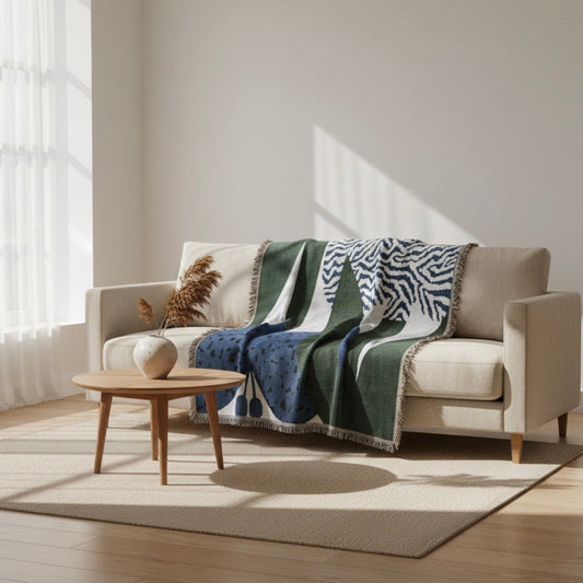 Beige armchair with a patterned blanket draped over it in a bright living room.