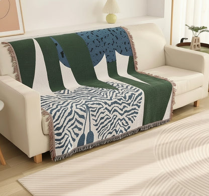 Decorative throw blanket with animal print draped over a sofa in a living room.