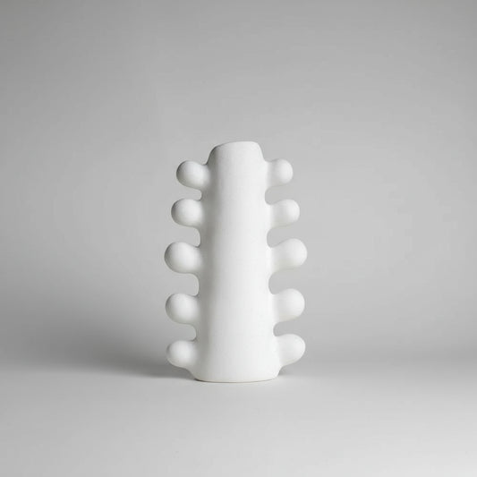 White textured vase on a beige background