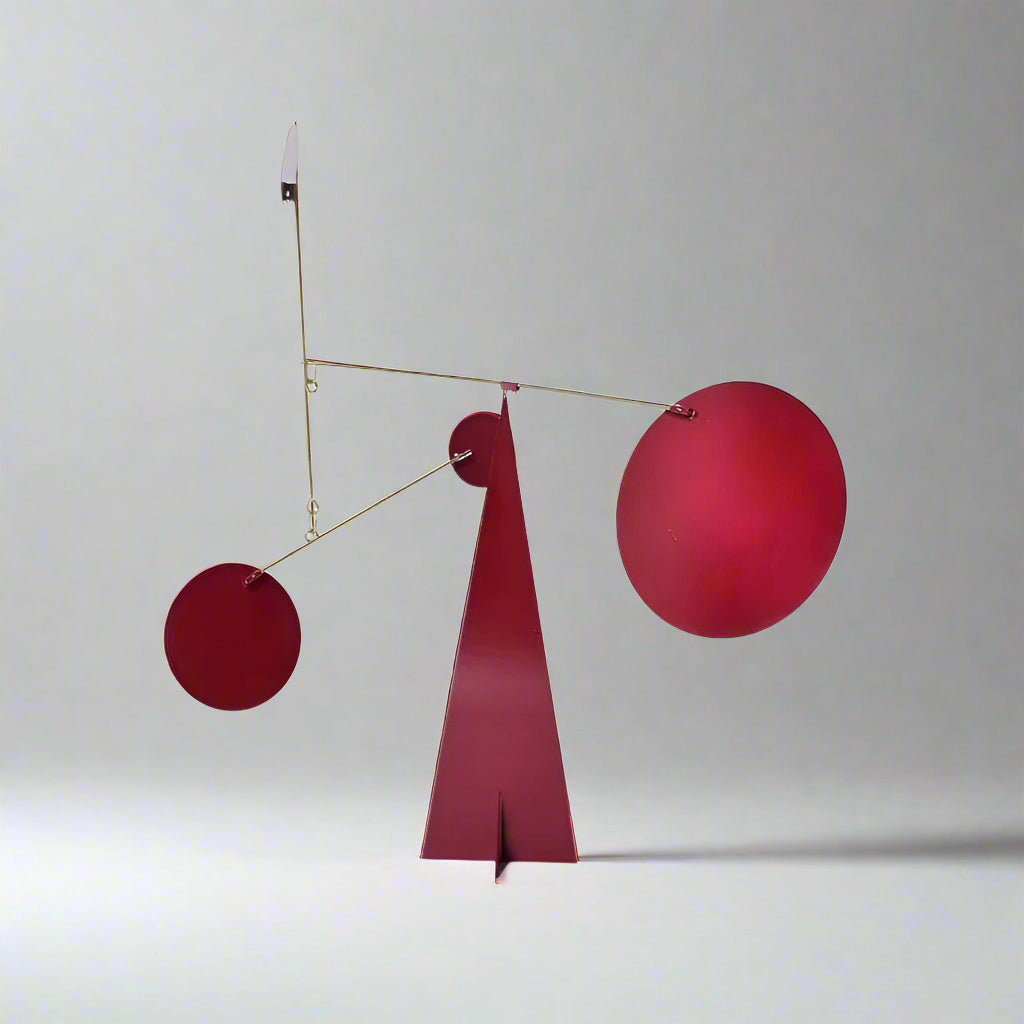 Red abstract sculpture with geometric shapes on a white background