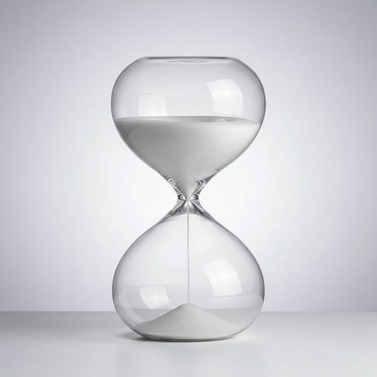 Clear glass hourglass on a white background