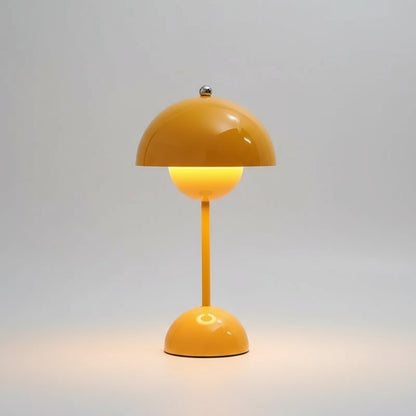 Yellow table lamp on a surface with a blurred background