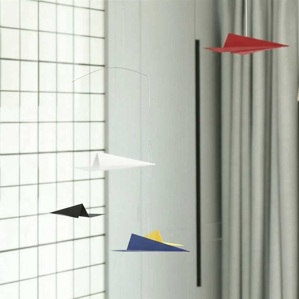 Colorful geometric wall art on a white wall with grid pattern