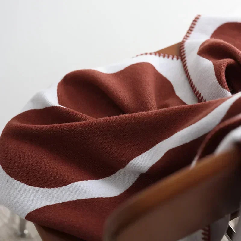 Close-up of a brown and white striped fabric on a chair.