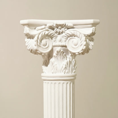 Decorative white column capital on a beige background