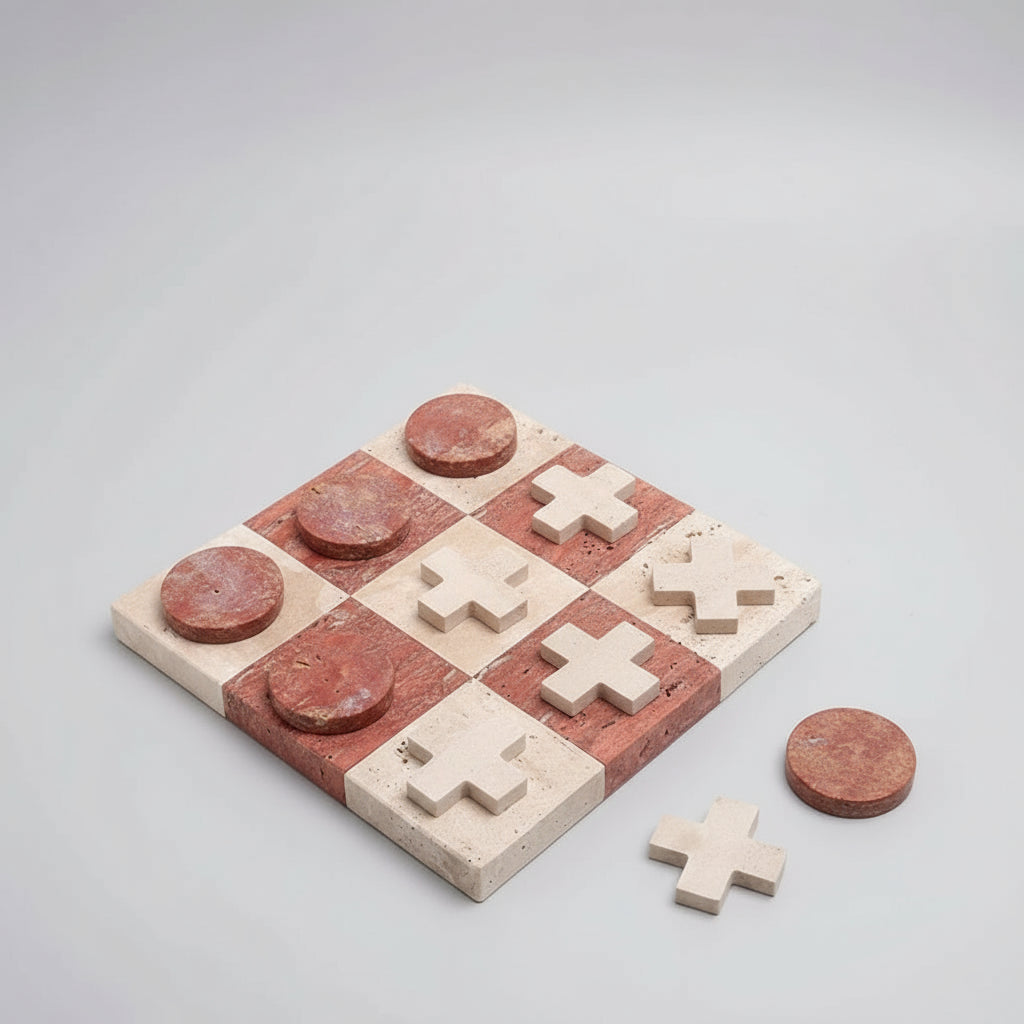 Marble tic tac toe board with red and beige pieces on a light gray background
