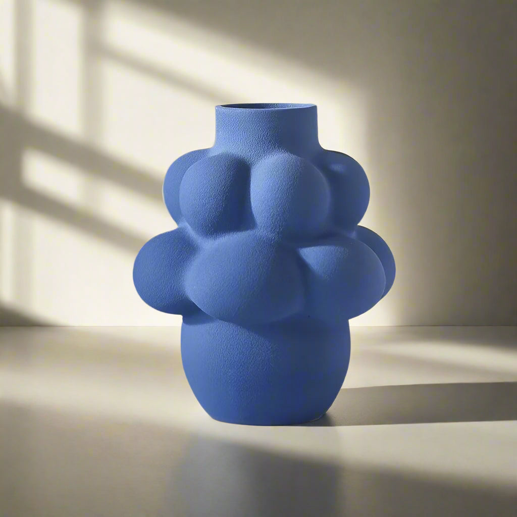 Blue textured vase on a light gray background