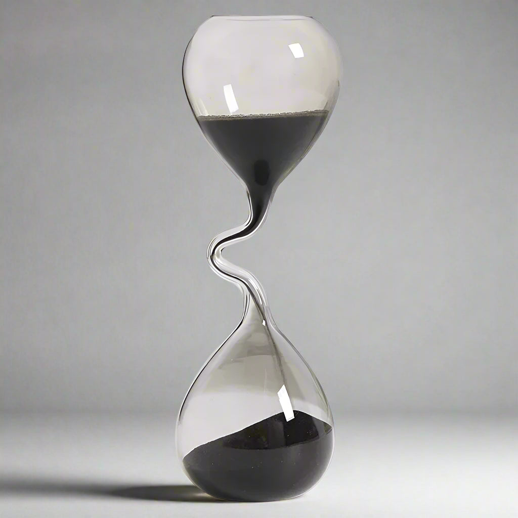 Hourglass with sand flowing from top to bottom on a white background