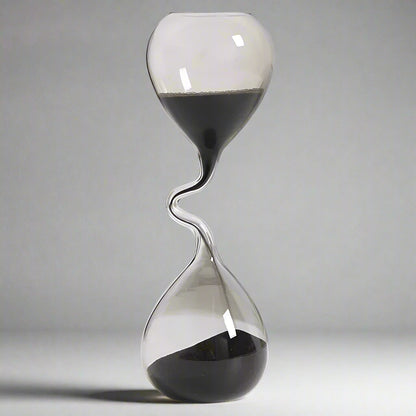 Hourglass with sand flowing from top to bottom on a white background