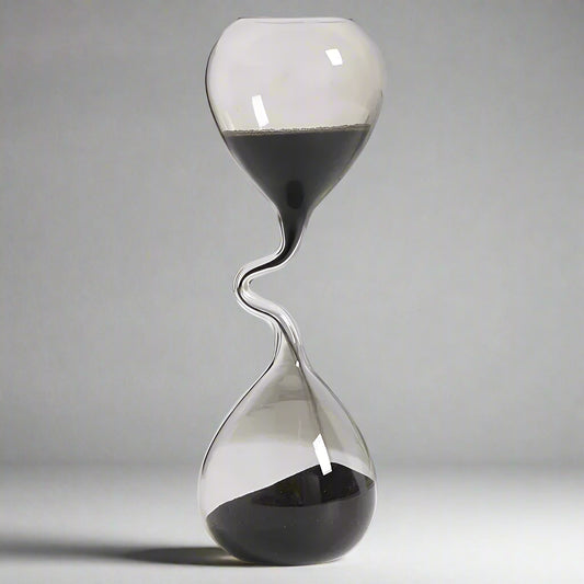 Hourglass with sand flowing from top to bottom on a white background