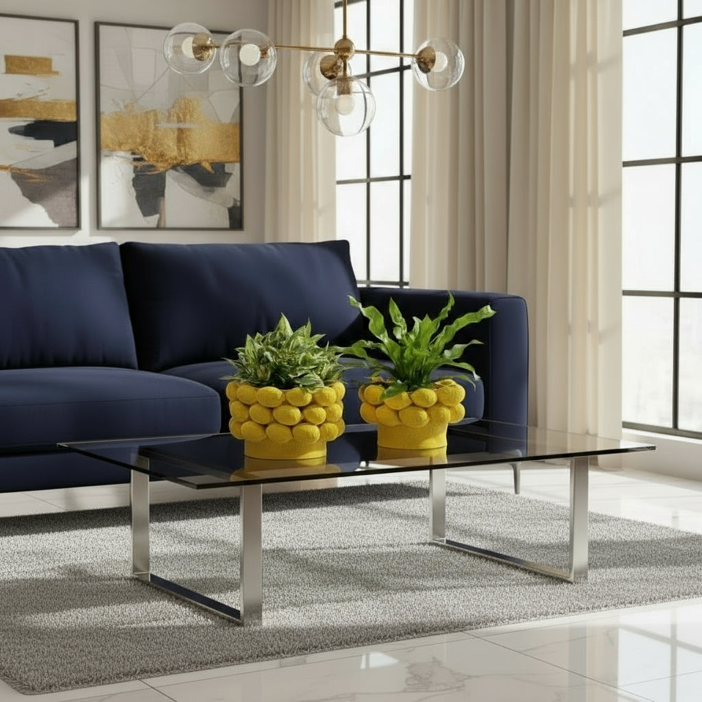 Two yellow lemon-shaped planters with green plants on a windowsill.