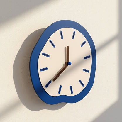 Wall clock with blue frame and white face on a light background