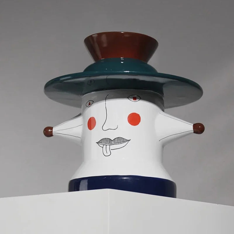 Abstract sculpture vase with a face design on a gray background