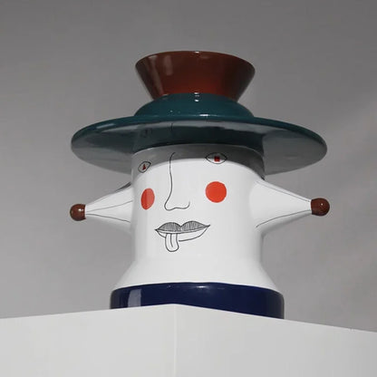 Abstract sculpture vase with a face design on a gray background