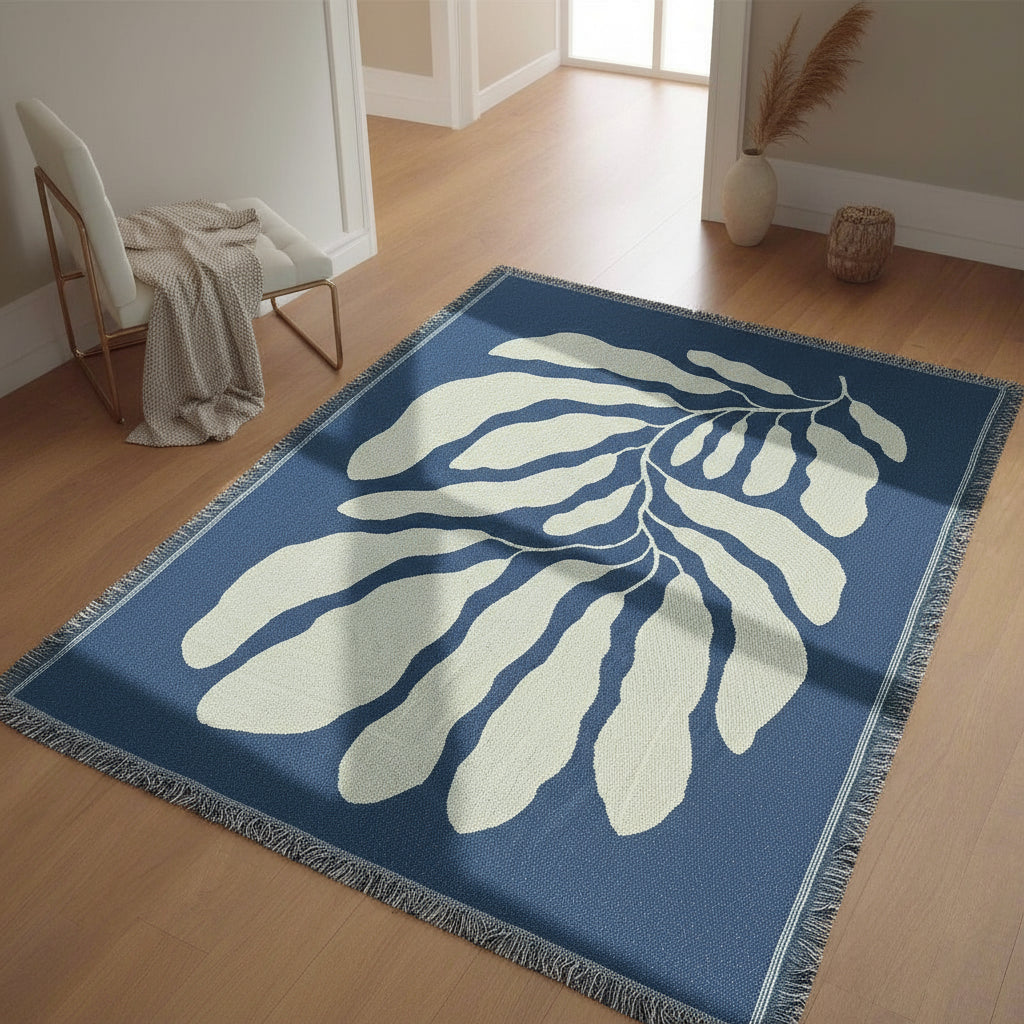 Blue and white leaf-patterned rug on a wooden floor