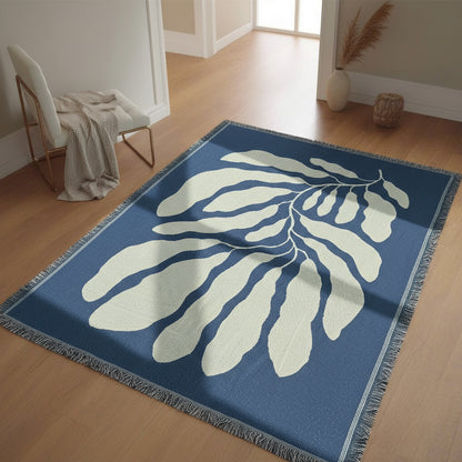 Blue and white leaf-patterned rug on a wooden floor