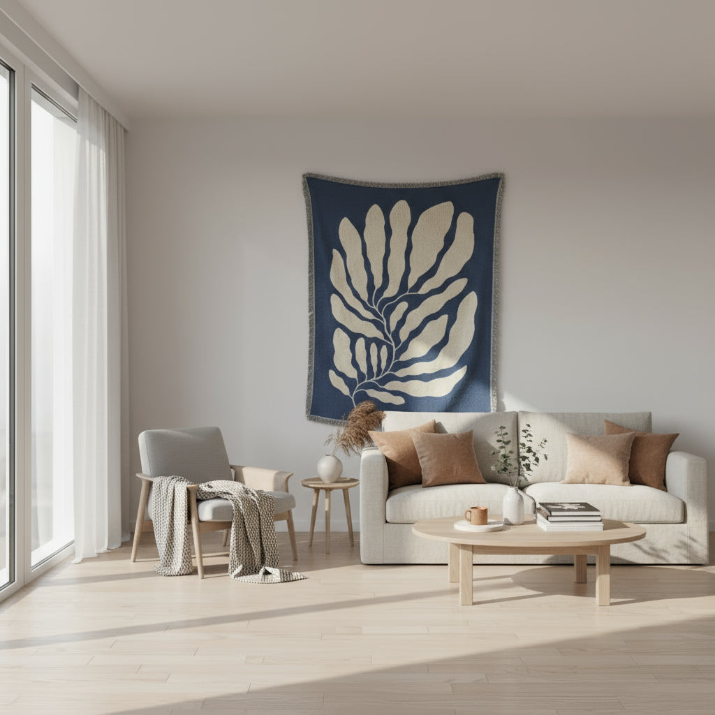 Blue blanket with beige leaf pattern on a white background