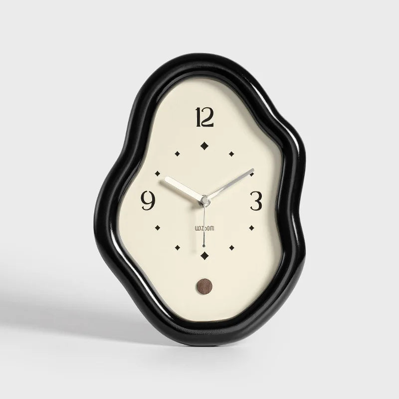 Wall clock with black frame and white face on a light gray background