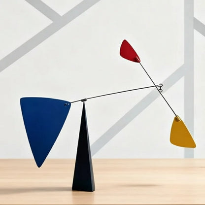 Colorful abstract sculpture on a wooden surface with a geometric background