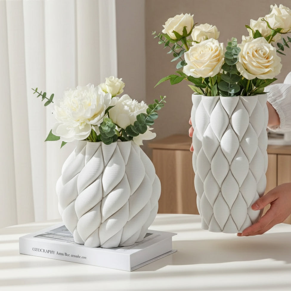 White textured vases on a light surface with a blurred background