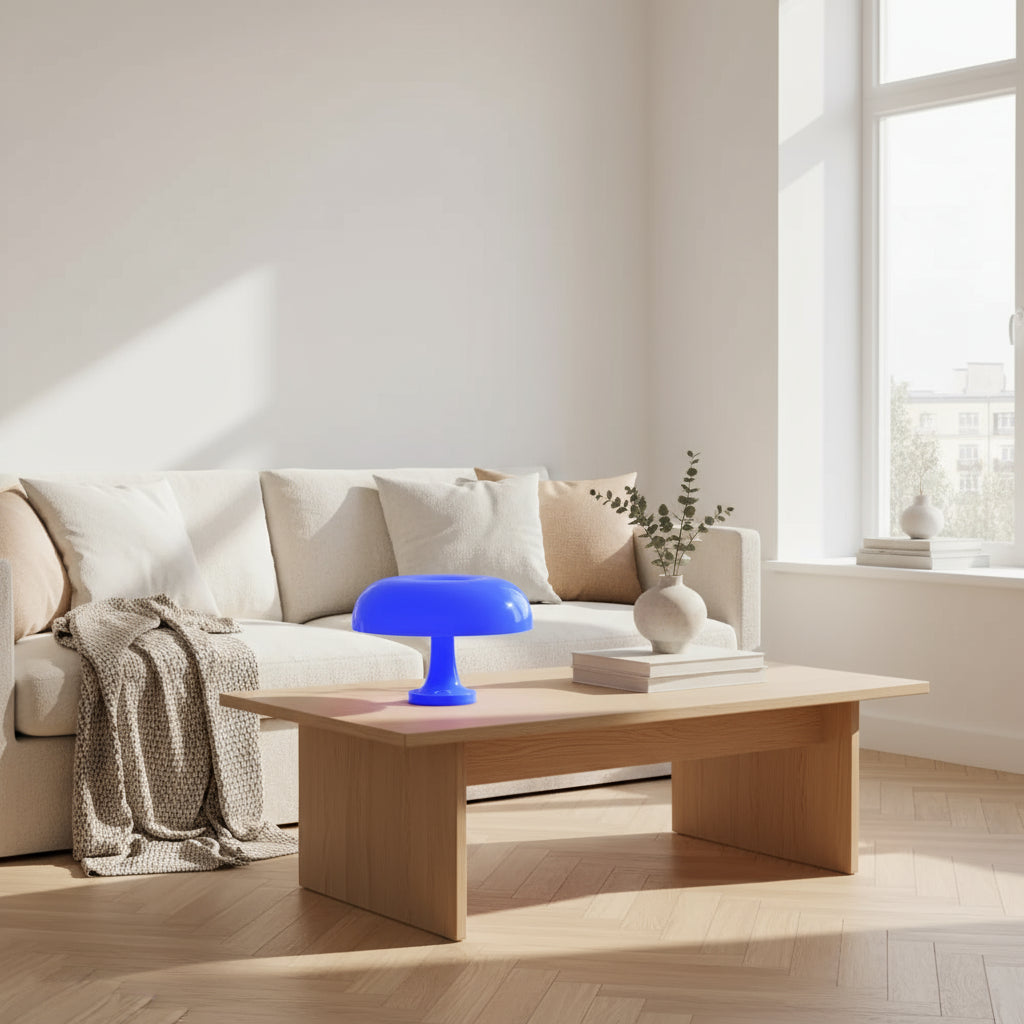 Blue lamp on a table with a vase of sunflowers in the background