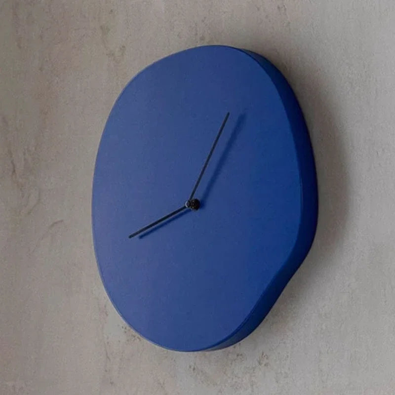 Blue wall clock on a light gray wall