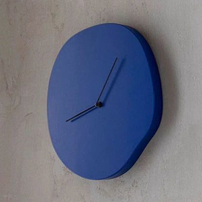 Blue wall clock on a light gray wall