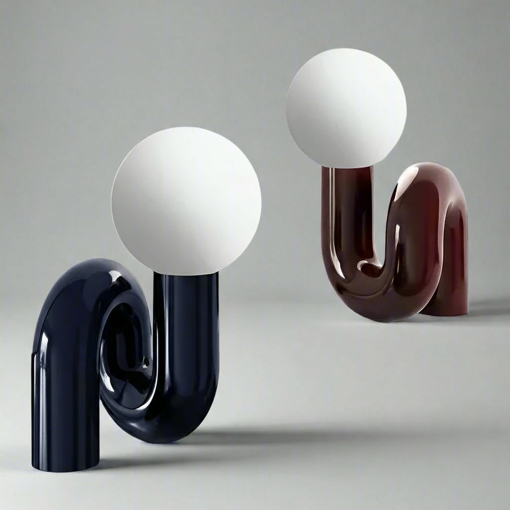 Two decorative lamps with spherical tops and curved bases on a light gray background.