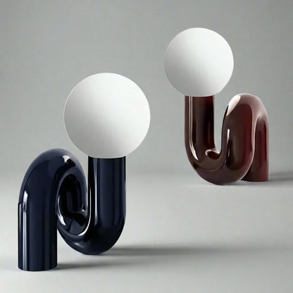 Two decorative lamps with spherical tops and curved bases on a light gray background.