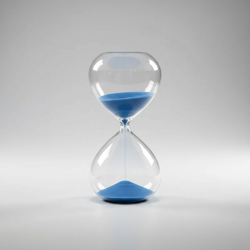 Hourglass with blue sand on a soft white background
