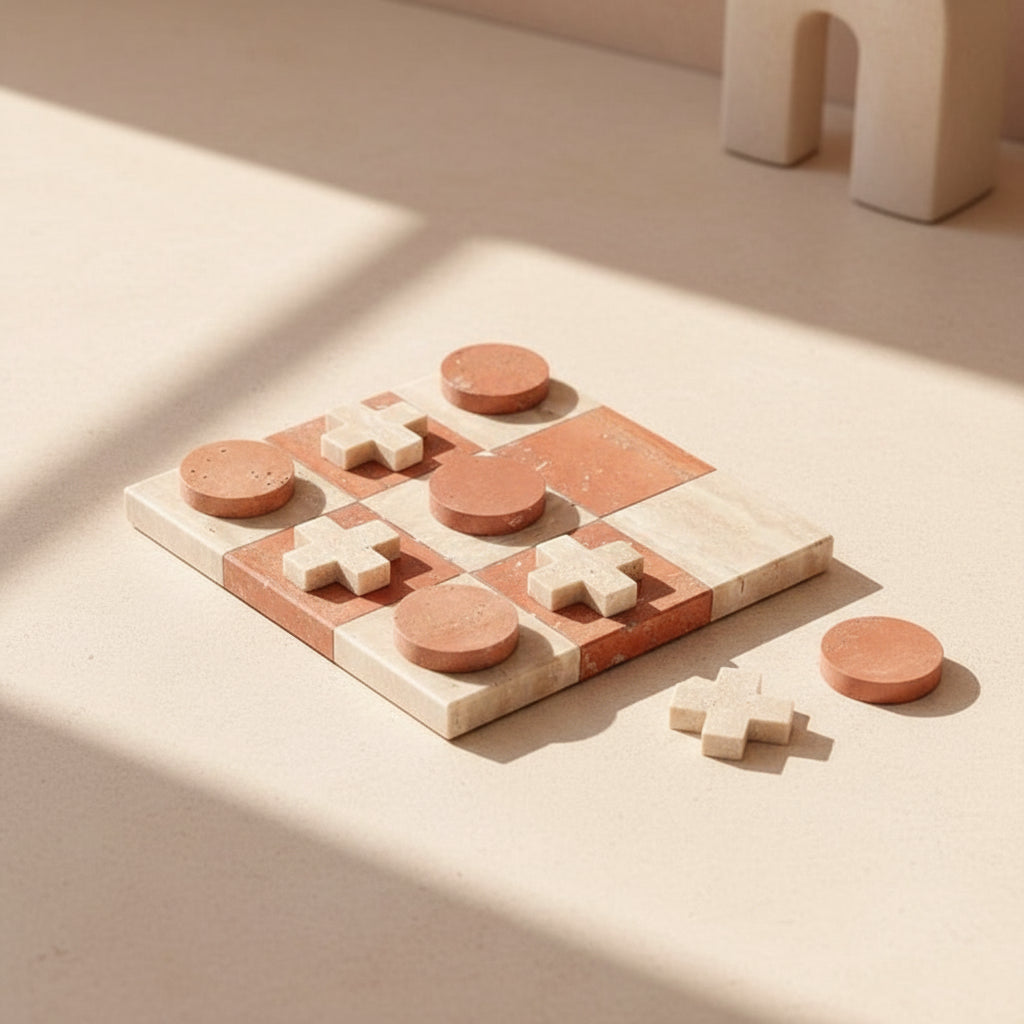 marble tic tac toe board with pieces on a dark surface
