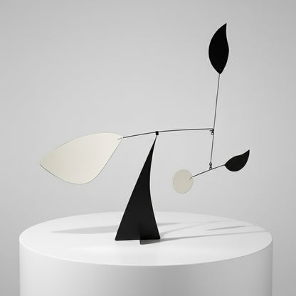 Abstract sculpture with black and white elements on a gray background