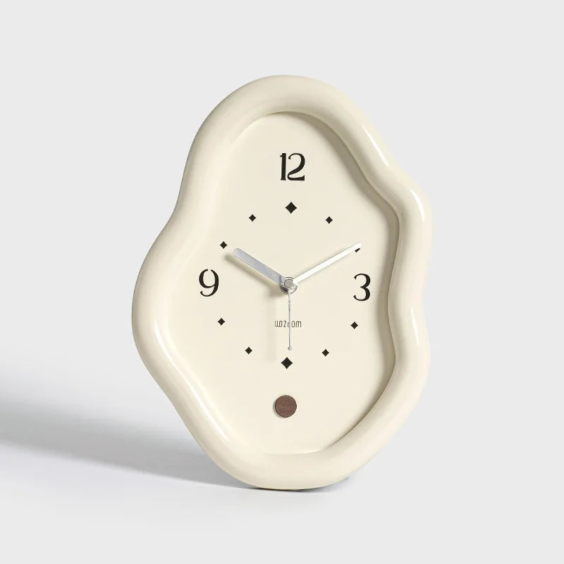 Decorative wall clock with a unique, cloud-like design on a light gray background
