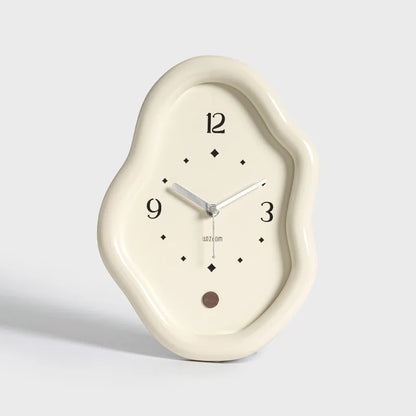 Decorative wall clock with a unique, cloud-like design on a light gray background
