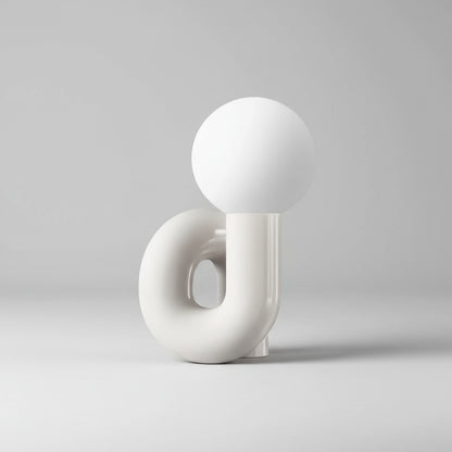 white decorative lamp with spherical tops and curved base