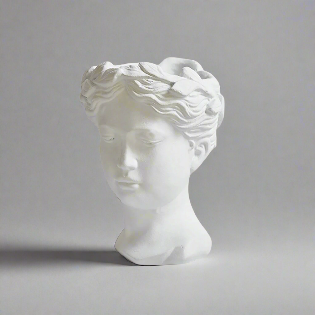 White marble bust  vase of Aphrodite figure on a gray background
