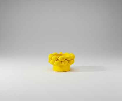 Yellow textured vase on a light gray background